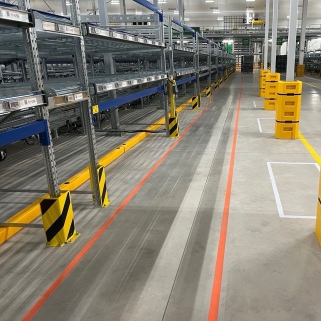 Floor rail bumper installed beneath racking and machinery to protect critical uprights and delicate equipment from forklift tines and MHE impacts.