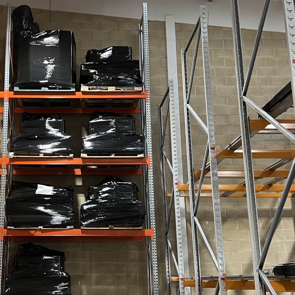 Warehouse utilising newly installed pallet racking for outgoing packages, positioned next to push-back racking to showcase full storage height and efficiency.