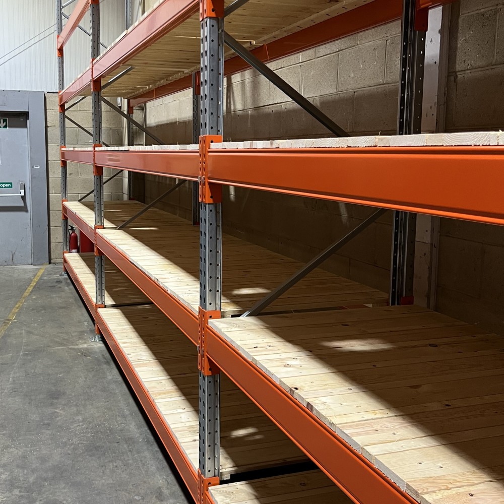 Pallet racking fitted with wooden slats, designed for small part storage, allowing for labelled organisation of fixings and fastenings.