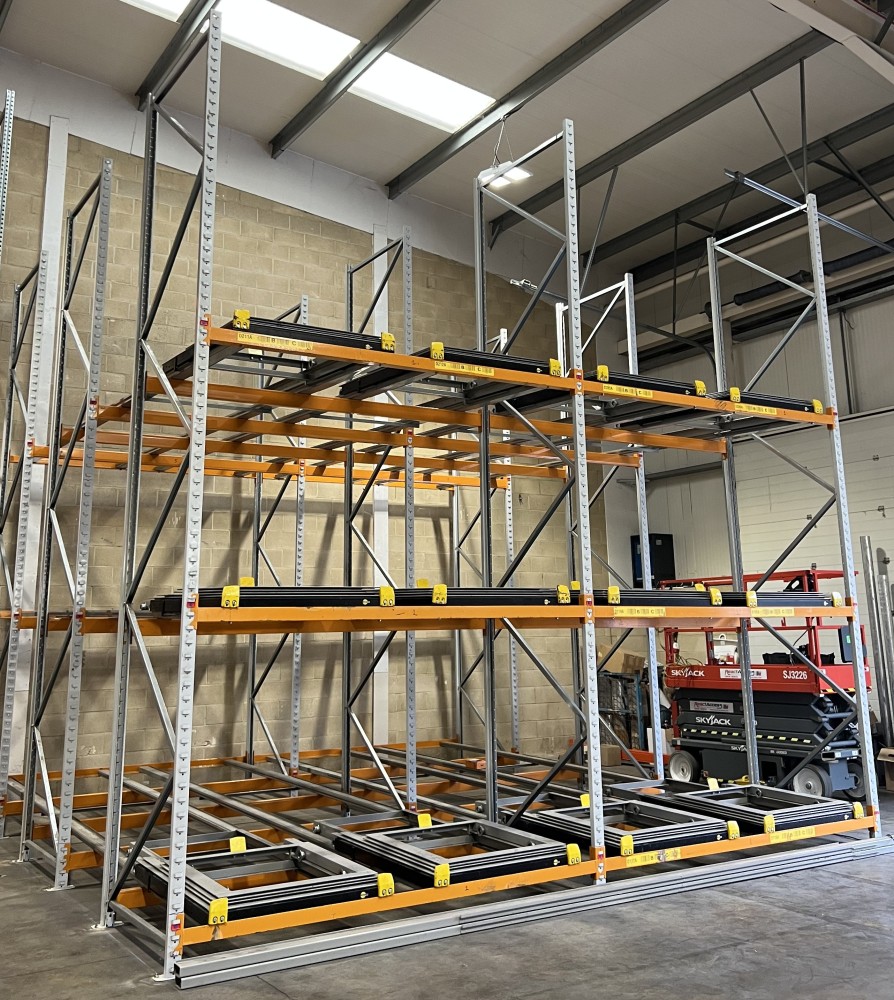 Fully installed push-back racking system with four bays and three beam levels, ready for warehouse storage use.